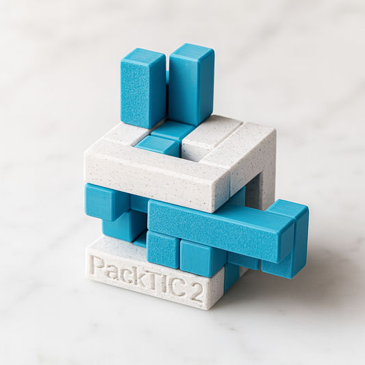 PackTIC 2 mechanical puzzle on white marble surface