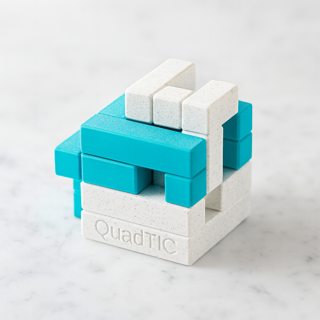 QuadTIC mechanical puzzle on white marble surface