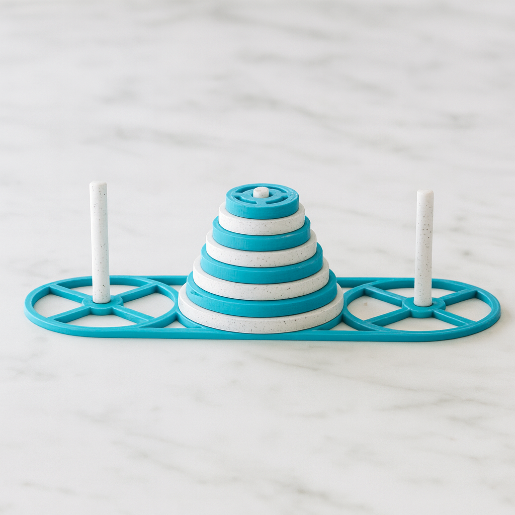 Tower of Hanoi mechanical puzzle on white marble surface
